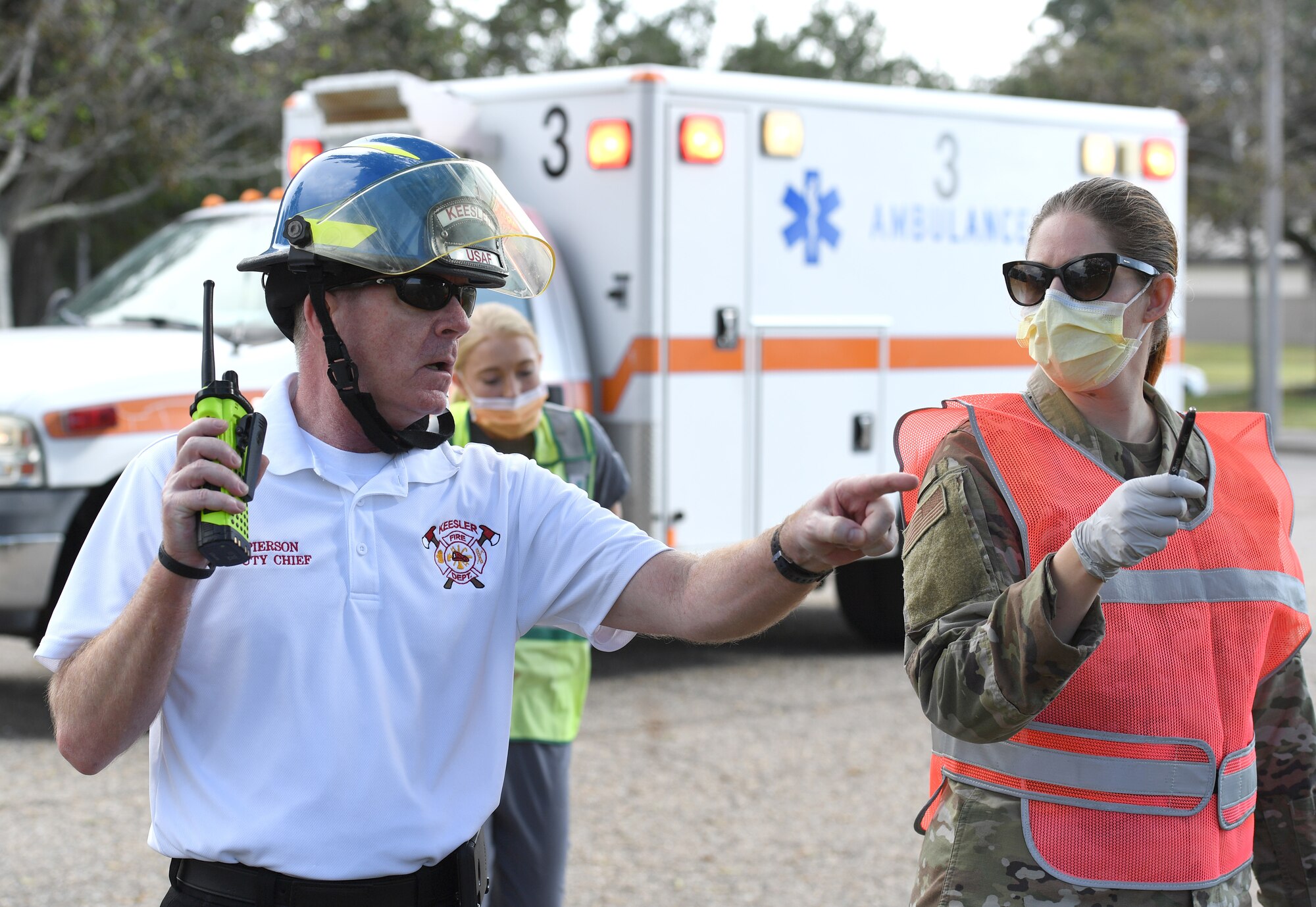 Gary Pierson, 81st Civil Engineering Squadron assistant fire chief, provides instruction to first responders during an active shooter exercise outside the Taylor Logistics Center at Keesler Air Force Base, Mississippi, Oct. 21, 2021. The scenario included an active duty Air Force member who simulated open fire in order to test the base's ability to respond to and recover from a mass casualty event. (U.S. Air Force photo by Kemberly Groue)