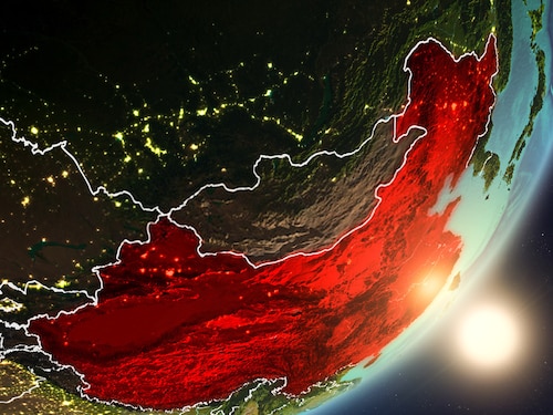 Shot of a globe with the sun rising on an ascendant China painted in red.