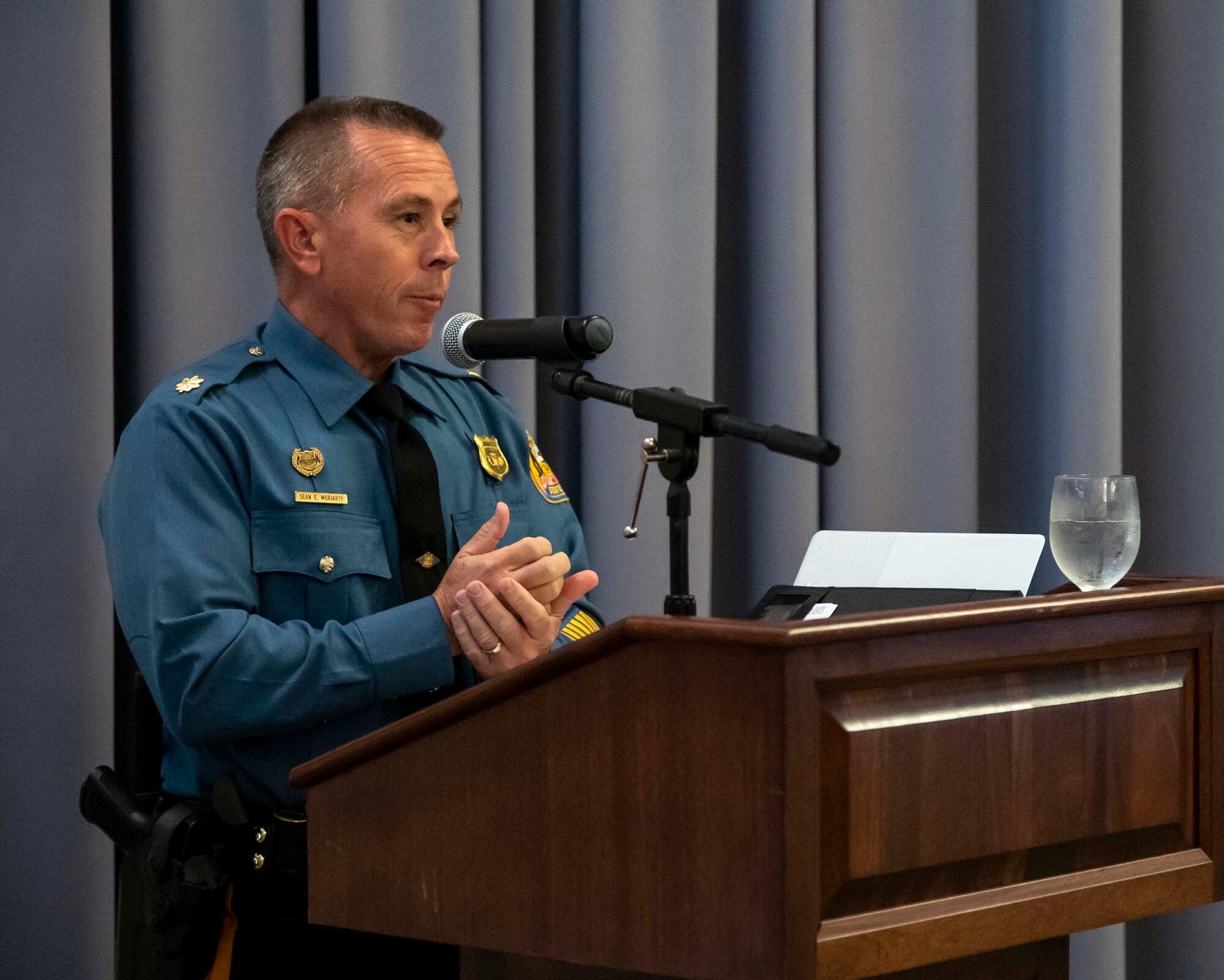 Maj. Sean Moriarty, Delaware State Police administrative officer and Air Mobility Command civic leader, speaks during the 2021 Honorary Commander Induction Ceremony Oct. 22, 2021, at Dover Air Force Base, Delaware. Moriarty spent two years as the 436th Security Forces Squadron HCC and one year as the 436th Airlift Wing vice HCC before becoming an AMC civic leader. (U.S. Air Force photo by Senior Airman Stephani Barge)