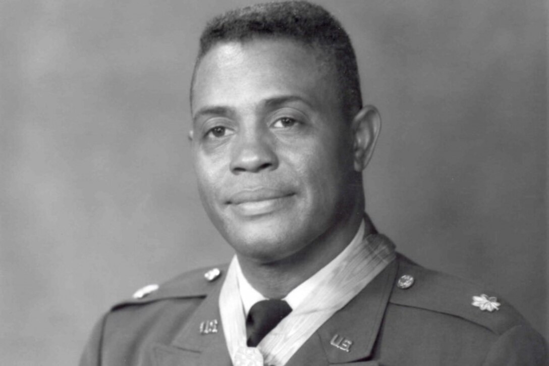 A man in dress uniform poses for an official photo.