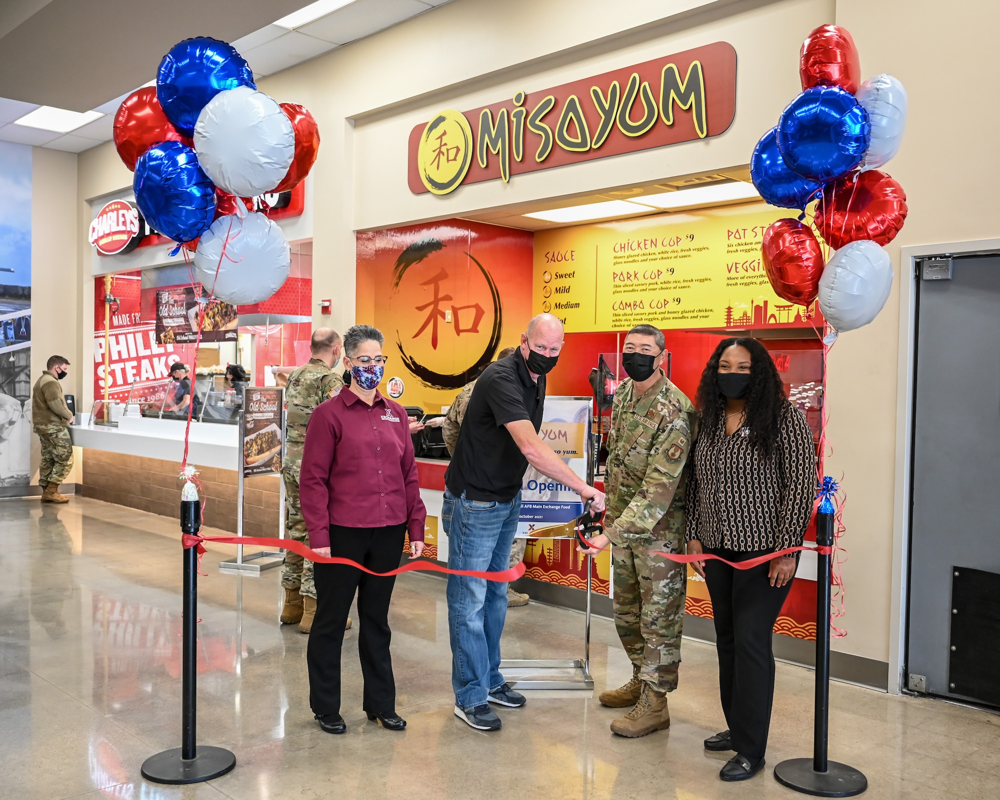 Tammy Hairston, AAFES general manager, Nate Hatch, misoYUM owner, Col. Peter Feng, 75th Air Base Wing vice commander, and Dahlia Haliburton, AAFES business manager, cut a ribbon in front of the misoYum restaurant.