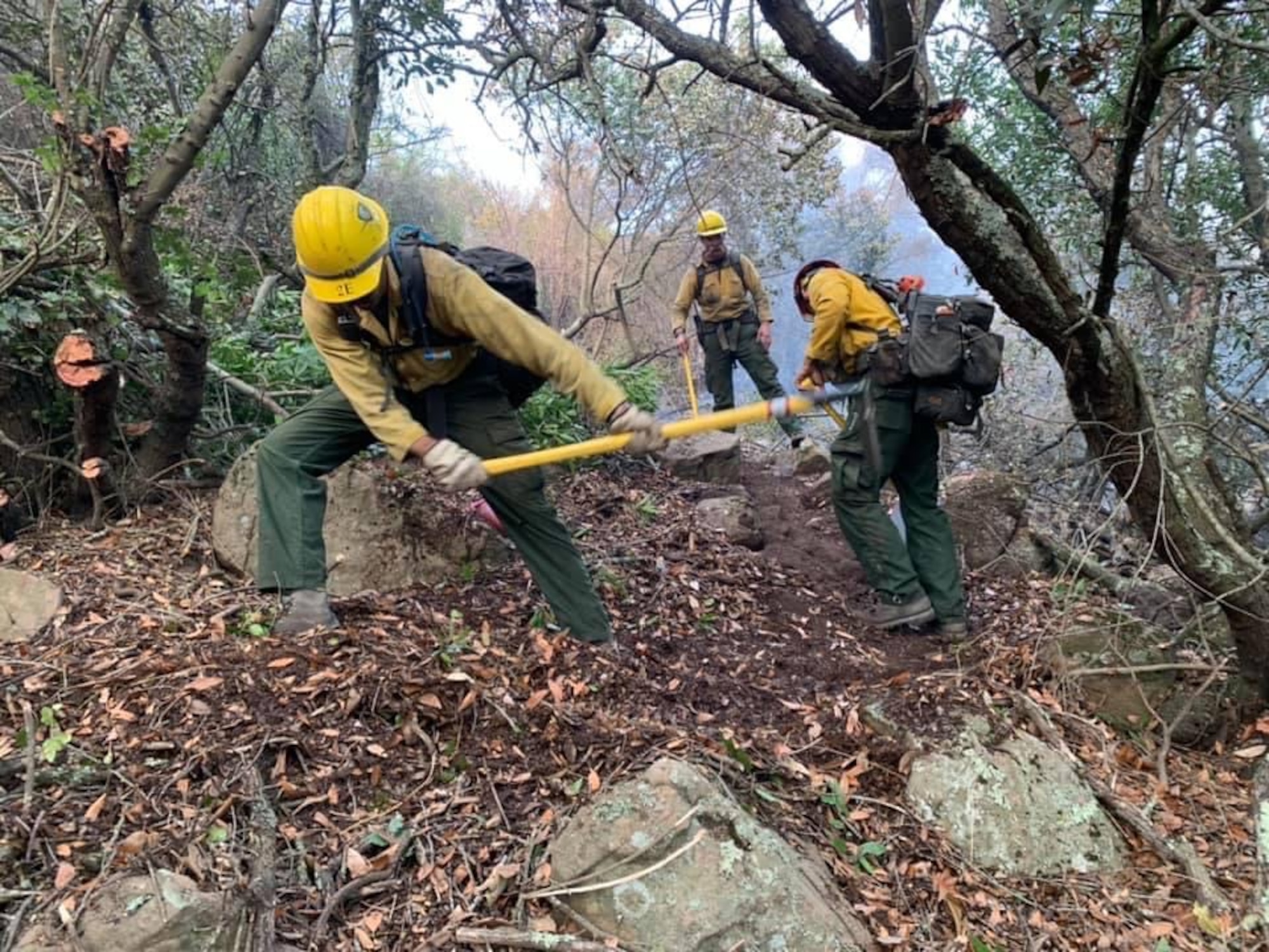 Firefighters assigned to the 30th Civil Engineer Squadron sift the ground to combat the Alisal Fire Oct. 11, 2021, at Los Padres National Forest in Goleta, Calif. Sifting the ground is part of the firefighters training they take at Vandenberg. (Courtesy photo)
