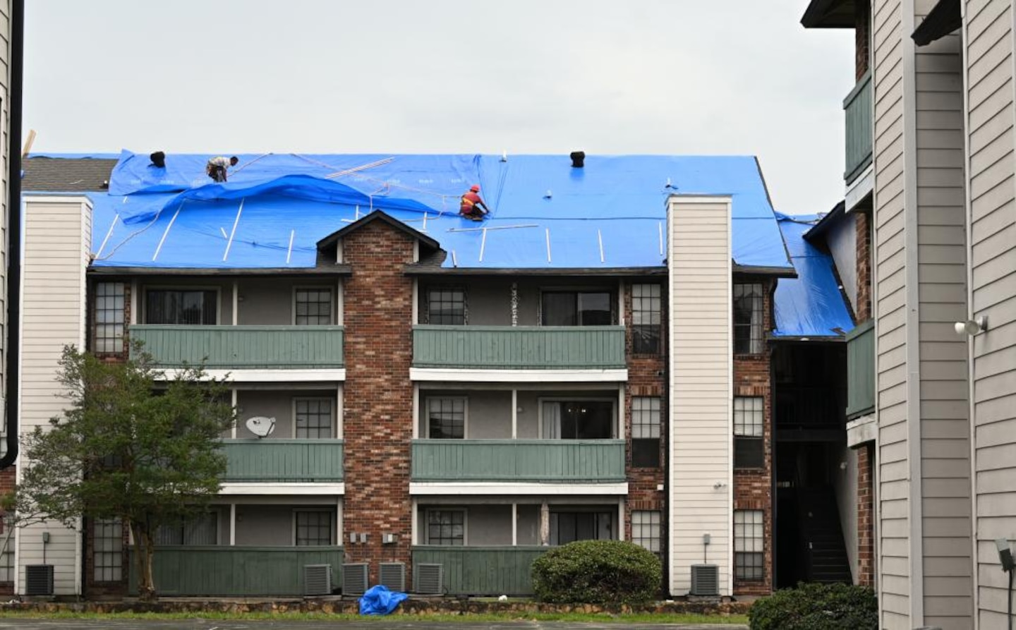 The U.S. Army Corps of Engineers installs temporary roofing, or Blue Roofs, on a low-income apartment building in New Orleans Oct. 24. In total USACE installed Blue Roofs on 90 buildings at four sites within the greater New Orleans area. This was a special request approved through the Federal Emergency Management Agency and the state of Louisiana and is equivalent to installing more than 300 blue roofs on individual homes.