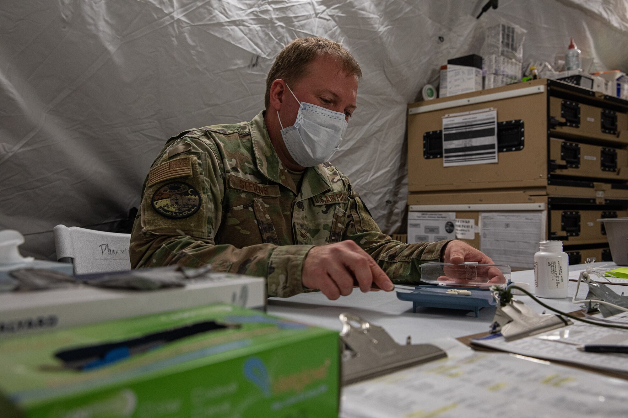 U.S. Air Force Staff Sgt. Dustin Stevens, Task Force Holloman pharmacy lead, counts medication prescribed to Afghan evacuees on Holloman Air Force Base, New Mexico, Oct. 14, 2021. The Department of Defense, through U.S. Northern Command, and in support of the Department of Homeland Security, is providing transportation, temporary housing, medical screening, and general support for at least 50,000 Afghan evacuees at suitable facilities, in permanent or temporary structures, as quickly as possible. This initiative provides Afghan personnel essential support at secure locations outside Afghanistan. (U.S. Army photo by Pfc. Anthony Sanchez)
