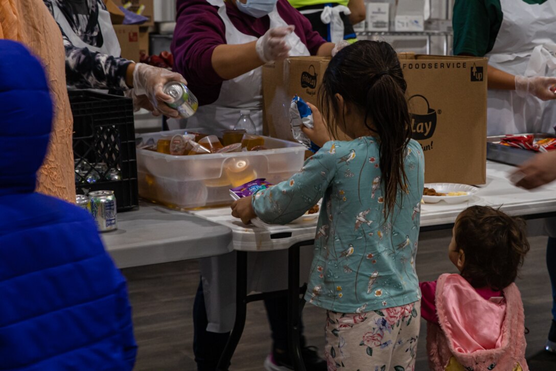 An Afghan child receives lunch in the new dining facility at Aman Omid Village on Holloman Air Force Base, New Mexico, Oct. 20, 2021. The Department of Defense, through U.S. Northern Command, and in support of the Department of Homeland Security, is providing transportation, temporary housing, medical screening, and general support for at least 50,000 Afghan evacuees at suitable facilities, in permanent or temporary structures, as quickly as possible. This initiative provides Afghan personnel essential support at secure locations outside Afghanistan. (U.S. Army photo by Pfc. Anthony Sanchez)