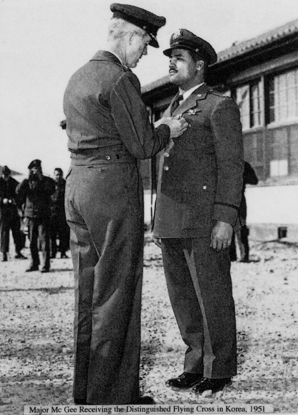 One officer pins a medal on another officer's chest.