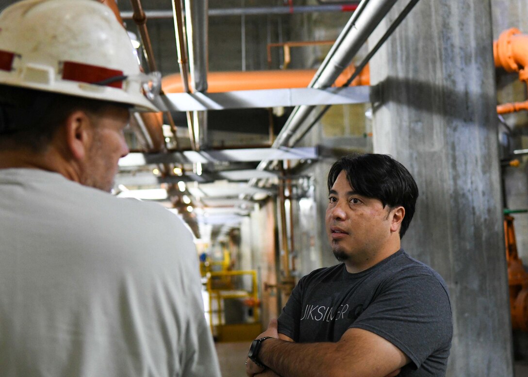 Thomas Yan, Antioch Middle School science teacher, actively listens to Senior Mechanic Greg Forte explain how often staff must regulate equipment to ensure the hydropower plant runs smoothly at the Old Hickory Hydropower Plant in Hendersonville, TN.
