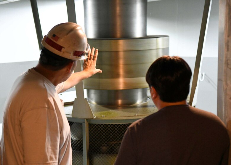 Old Hickory Senior Mechanic Greg Forte shows Antioch Middle School science teacher Thomas Yan where the original thruster bearings from 1956 are located on one of the underground hydropower generators at the Old Hickory Hydropower Plant in Hendersonville, TN.