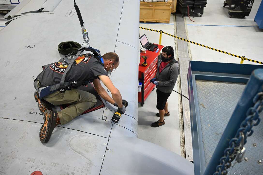 Ryan Paskett, left, and Chance Cottrell, 571st Aircraft Maintenance Squadron, work on A-10 Thunderbolt II, tail number 80-0264, at Hill Air Force Base, Utah,