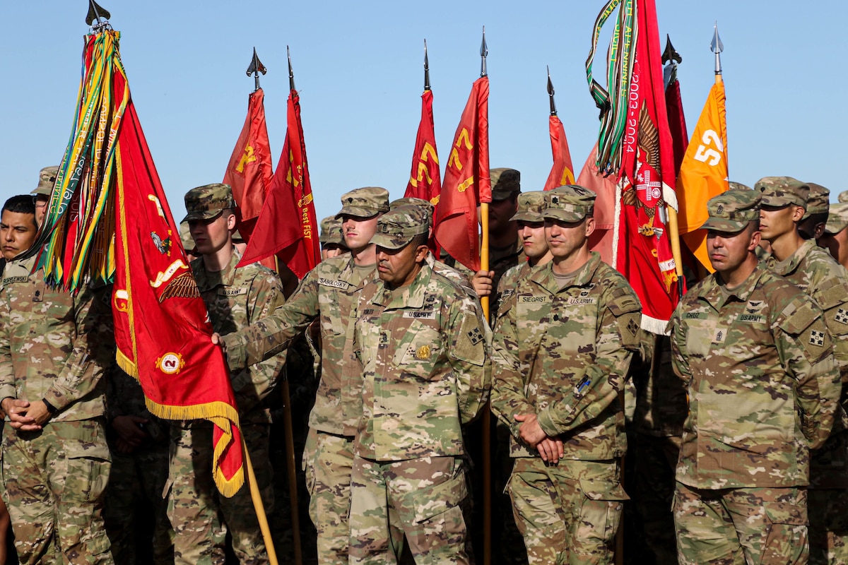 Service members stand in formation.