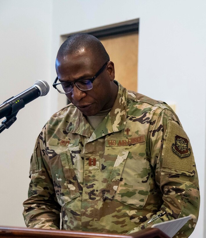Chaplain (Capt.) William Guy, 166th Airlift Wing chaplain, Delaware Air National Guard, reads an invocation during the 2021 Honorary Commander Induction Ceremony Oct. 22, 2021, at Dover Air Force Base, Delaware. Team Dover's HCC program first began in 1992 as a way to match leaders from across the state with commanders from the 436th Airlift Wing, 512th AW, Air Force Mortuary Affairs Operations, Armed Forces Medical Examiner System, Joint Personal Effects Depot and the 373d Training Squadron, Detachment 3. (U.S. Air Force photo by Senior Airman Stephani Barge)