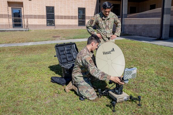 Photo of Airmen inspecting a multi-mission terminal