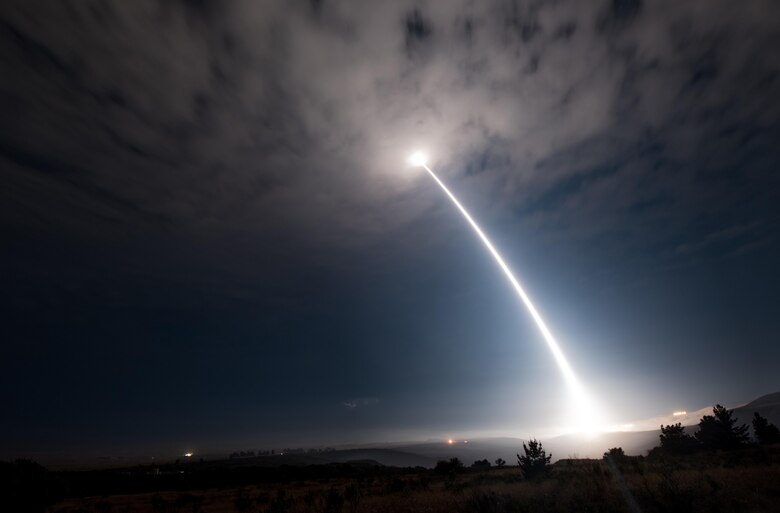 Missile test launch at night.