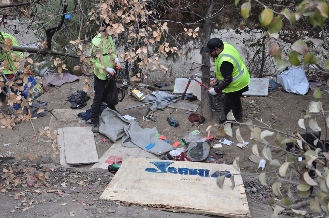 Workers remove trash from an abandoned homeless encampment, Sept. 27, 2021, near Whittier, California, as part of a two-week cleanup by the U.S. Army Corps of Engineers Los Angeles District. About 120 acres of creek and riverbank were cleared during the project.