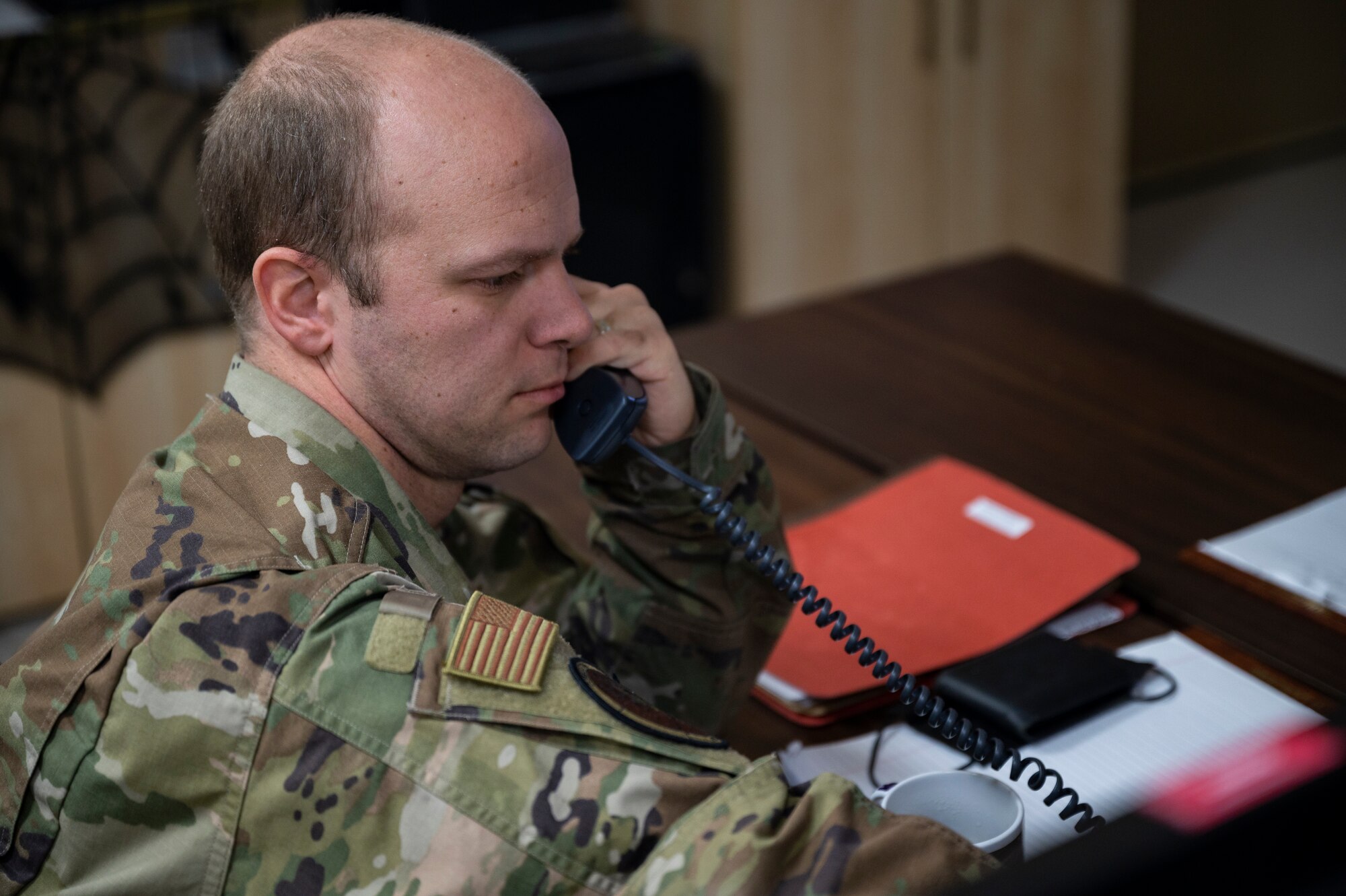 Senior Airman Craig Davenport, 386th Air Expeditionary Wing Command Post controller, answers a phone call at Ali Al Salem Air Base, Kuwait, Oct. 21, 2021.