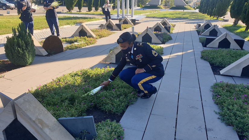 Members lay flowers at Tbilisi, Georgia military cemetery.