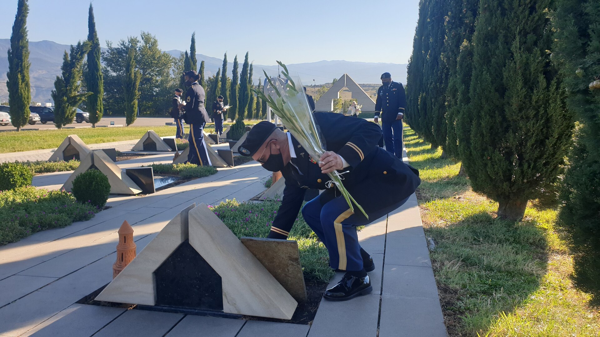 Members lay flowers at Tbilisi, Georgia military cemetery.