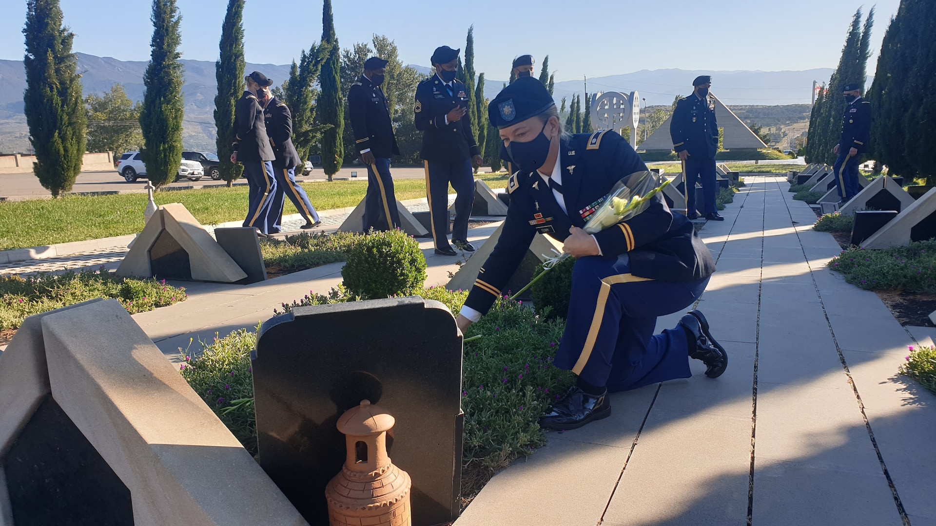 Members lay flowers at Tbilisi, Georgia military cemetery.