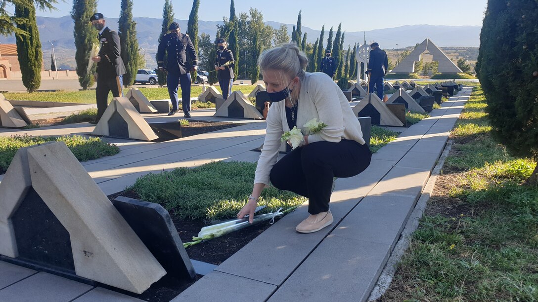 Members lay flowers at Tbilisi, Georgia military cemetery.