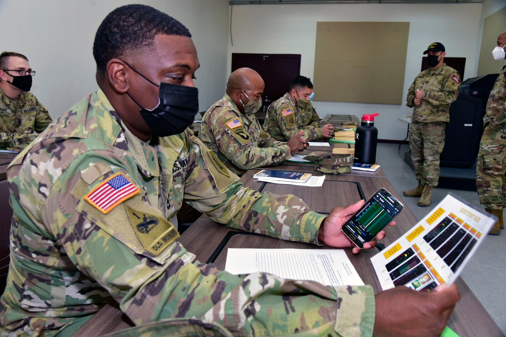 Soldiers assess the Heat Strain Decision Aid and Mental Acuity/2B ALERT app on a smartphone at Joint Base San Antonio-Camp Bullis.