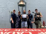 IMAGE: (From left to right) FCA2 (SW) Zachari Brown, FCA3 (SW) Raymond Castillo, Naval Surface Warfare Center Dahlgren Division Scientist Bradley Eidschun, FCA2 (SW) Jack Heyer and FCA2 (SW) Christian Mulrain pose for a photo after Eidschun is given the Sailor of the Week Award in April 2021. Eidschun spent about six months aboard the USS Monterey (CG 61) operating, updating and maintaining the vessel’s Virtualization Pilot Ship equipment.