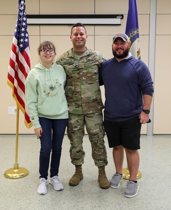 2nd Lt. Orlando Gonzalez poses for a photo with his husband and daughter Sept. 24, 2021, at Bowman Field Armory, after his commissioning ceremony. Gonzalez ended his 16 years of military service as an enlisted service member to begin his officer career.