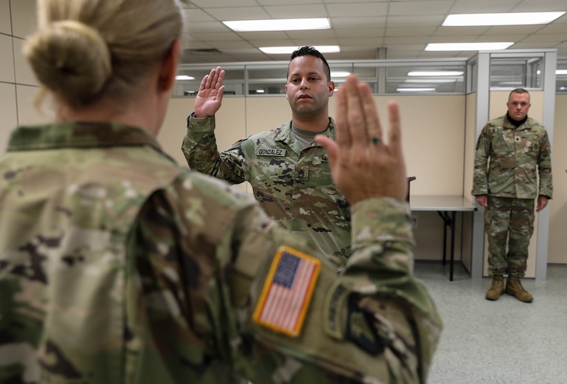 2nd Lt. Orlando Gonzalez raises right hand to swear in Sept. 24, 2021, at Bowman Field Armory, during commissioning ceremony. Gonzalez ended his 16 years of military service as an enlisted service member to begin his officer career.