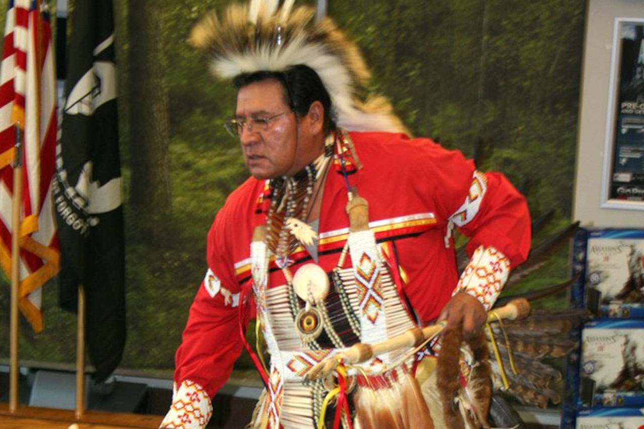 A Native American man dances.