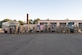 Airmen posing for group photo in front of vehicles and heavy equipment