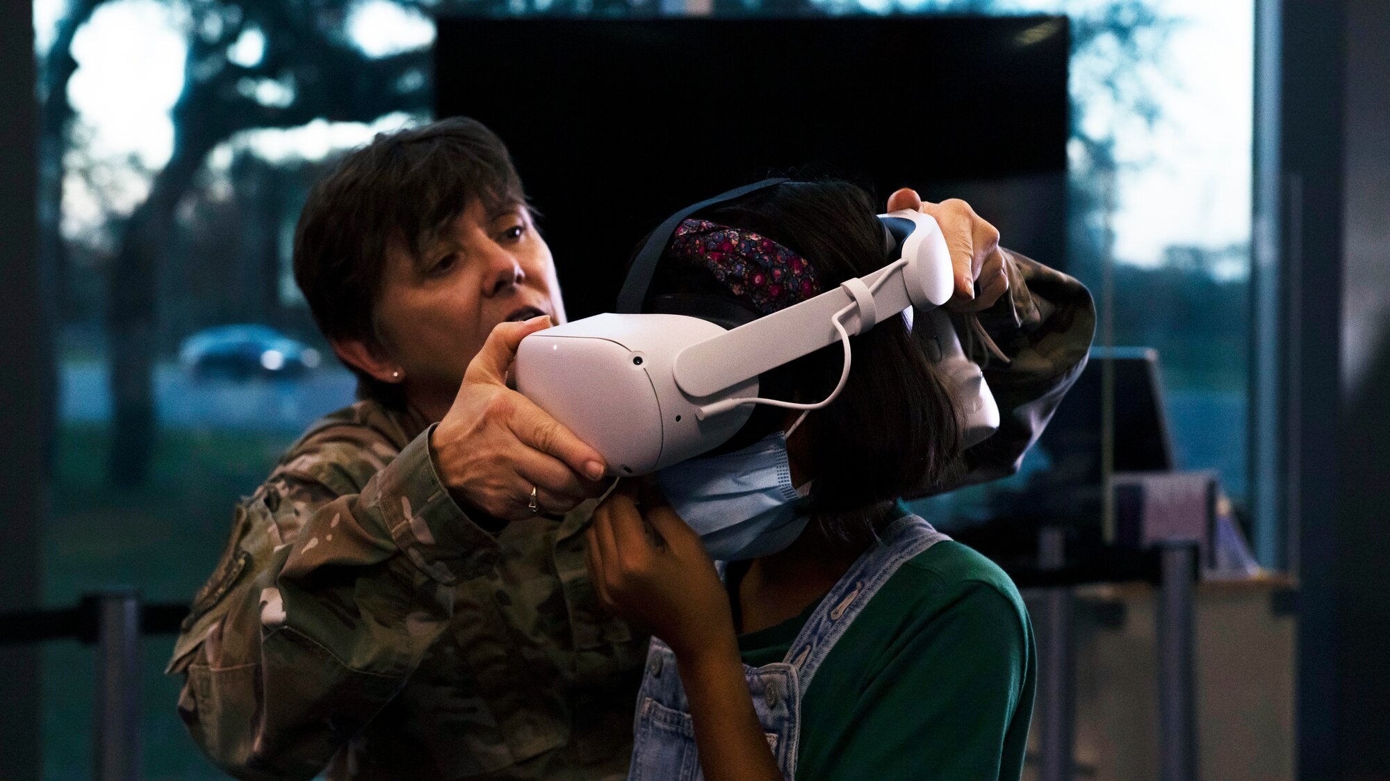 U.S. Air Force Col. Cheryl Lockhart, 6th Medical Group chief nurse, places a virtual reality headset on a student during the STEMtober event at the Museum of Science and Industry in Tampa, Florida, Oct. 21, 2021.