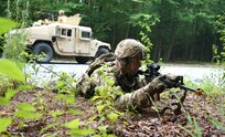 A Soldier from 1st Battalion, 109th Infantry Regiment, 2nd Infantry Brigade Combat Team, provides dismounted security while the High Mobility Multipurpose Wheeled Vehicle gunner provides rear security on the road during improvised explosive device training lane at Fort Indiantown Gap, Pa., on Aug. 11, 2021.