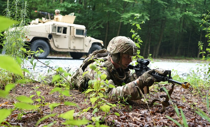 A Soldier from 1st Battalion, 109th Infantry Regiment, 2nd Infantry Brigade Combat Team, provides dismounted security while the High Mobility Multipurpose Wheeled Vehicle gunner provides rear security on the road during improvised explosive device training lane at Fort Indiantown Gap, Pa., on Aug. 11, 2021.