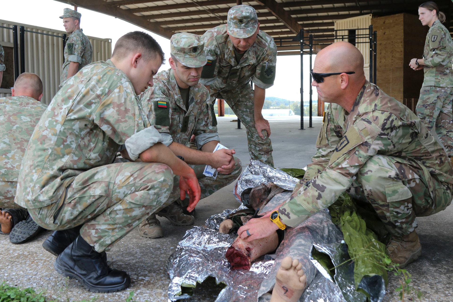 Sgt. 1st Class Dale Mahafkey, an Army combat medic and senior instructor with Medical Battalion Training Site at Fort Indiantown Gap, Pa., coaches Lithuanian Soldiers as they treat a simulated casualty on Sept. 10. Thirty-three Soldiers from Lithuania’s land forces reserve component came to Fort Indiantown Gap Sept. 6-17 for an annual platoon exchange, part of the Pennsylvania National Guard’s State Partnership Program.