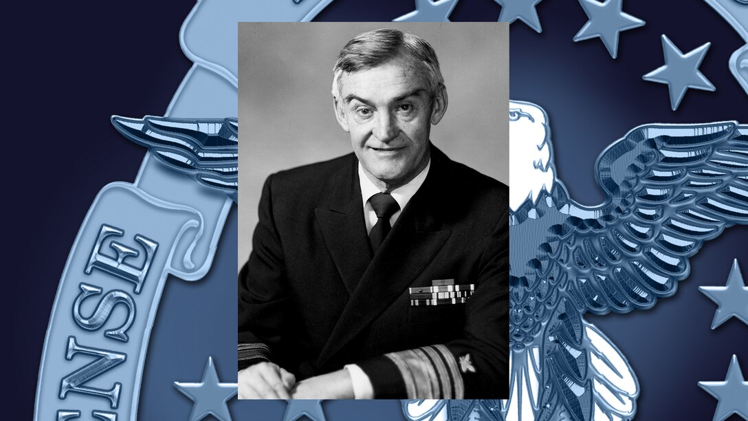 Male Navy Vice Admiral in front of a DLA logo template.