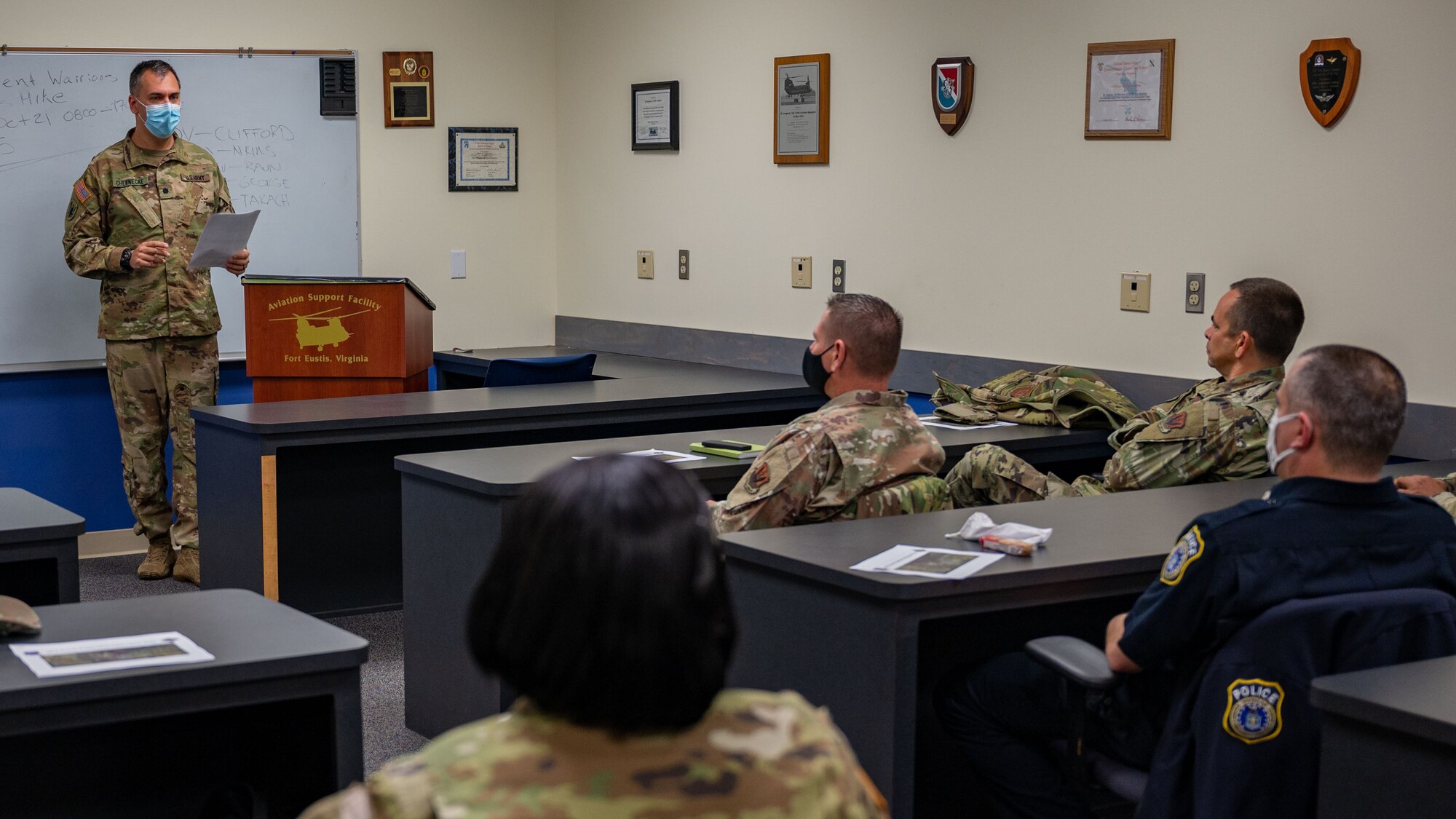 Lt. Col. Nathan Chernecke briefs a classroom