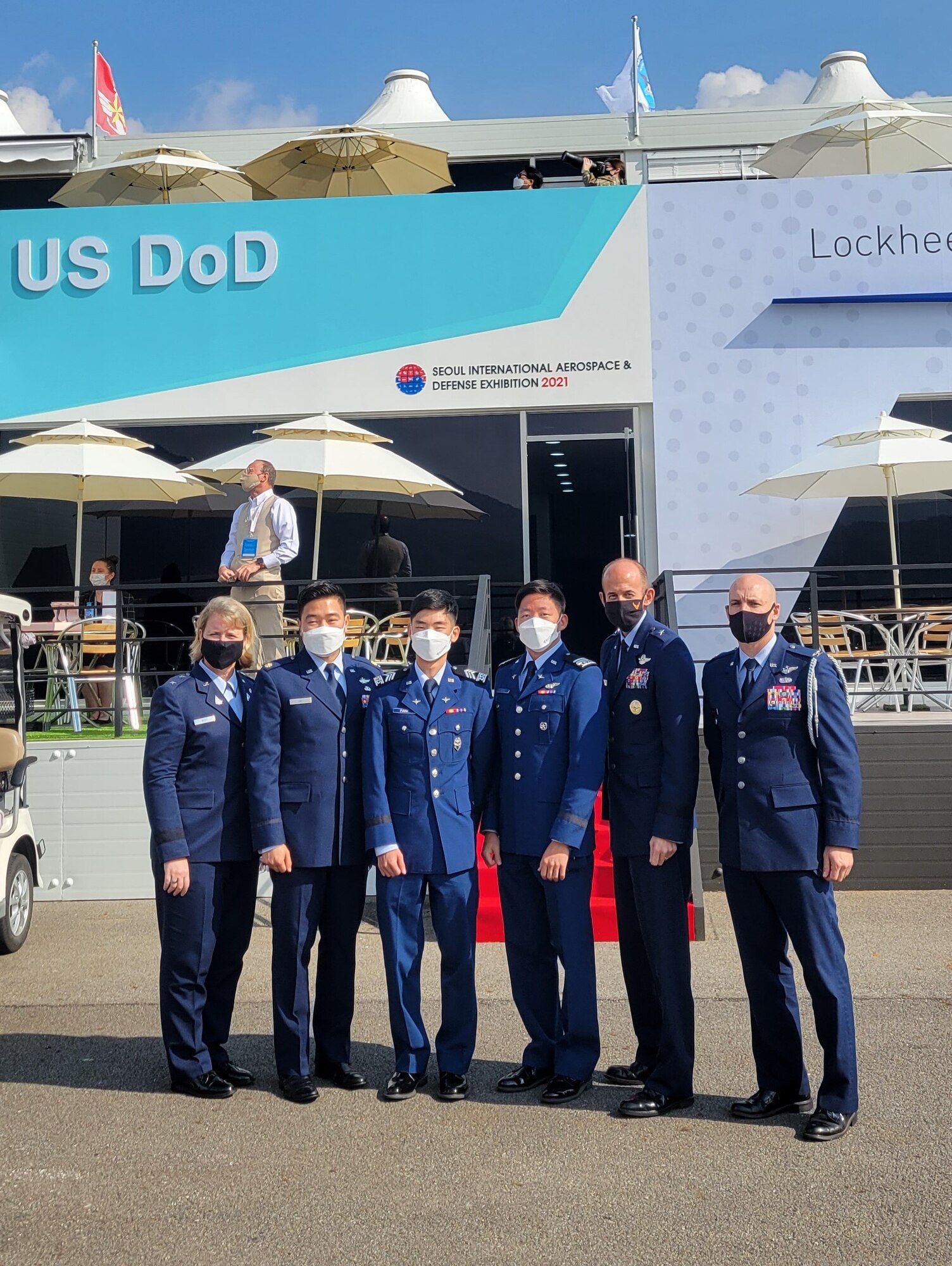 Cadet 2nd Class Brian Park and Cadet 1st Class David Song stand with Maj. Gen. DeAnna Burt, Maj. Hwang Ho, Brig. Gen. E. John Teichert, and Col. Glen Shilland, at the Seoul International Aerospace and Defense Exhibition.