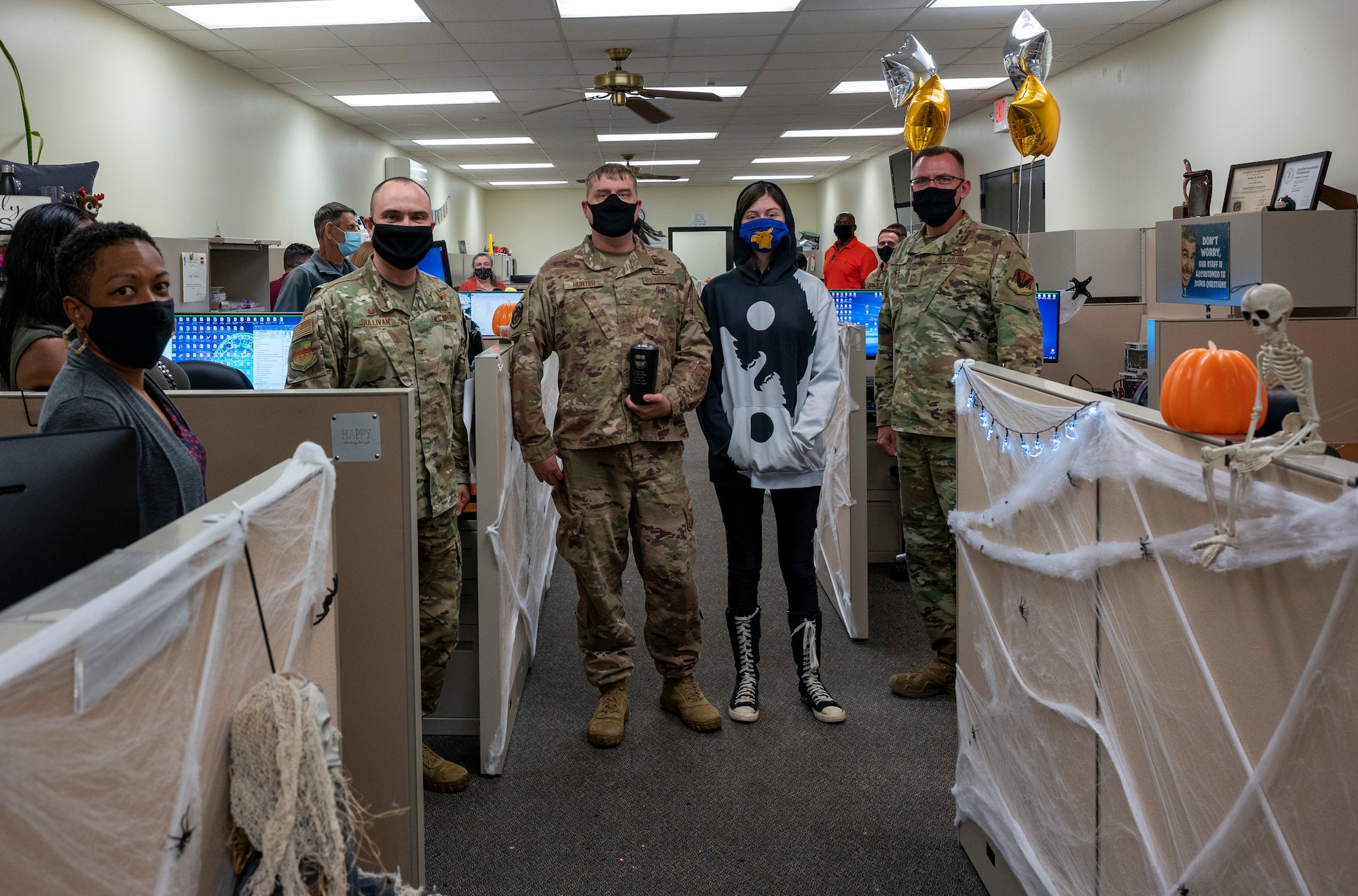 An Airman is photographed with members of leadership