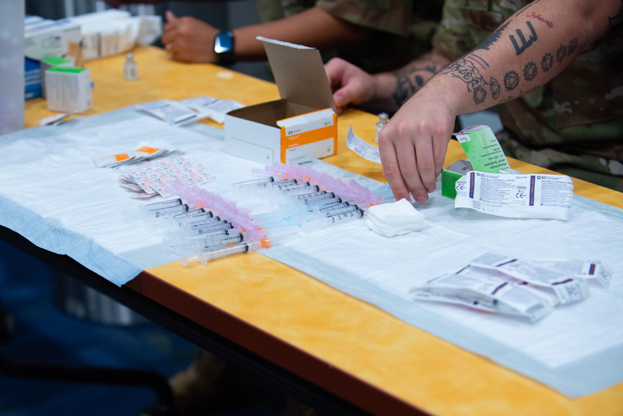 An Airman prepares vaccines