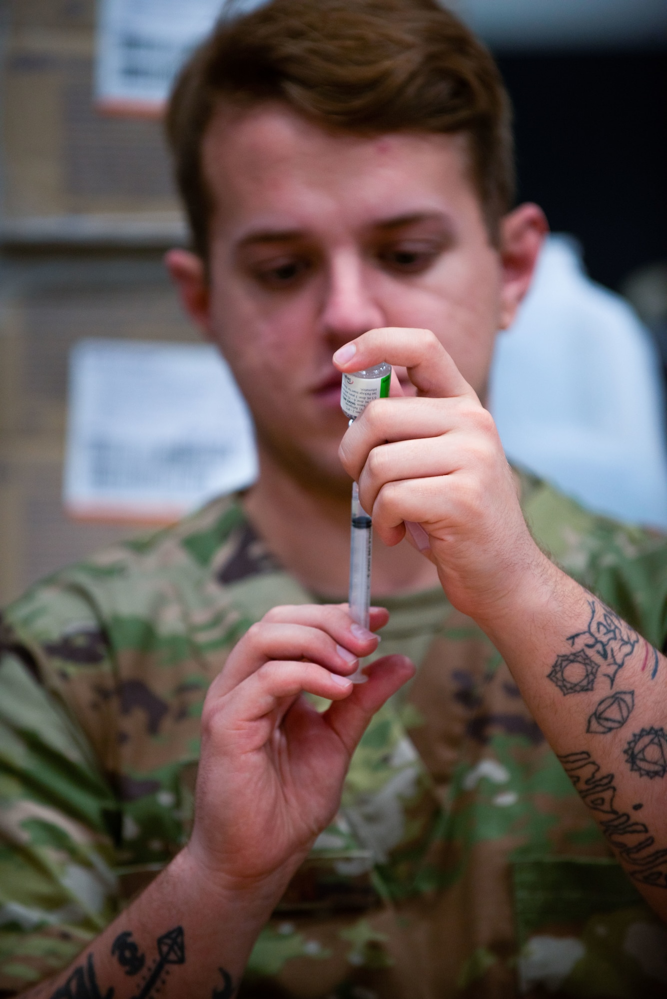An Airman prepares a vaccine