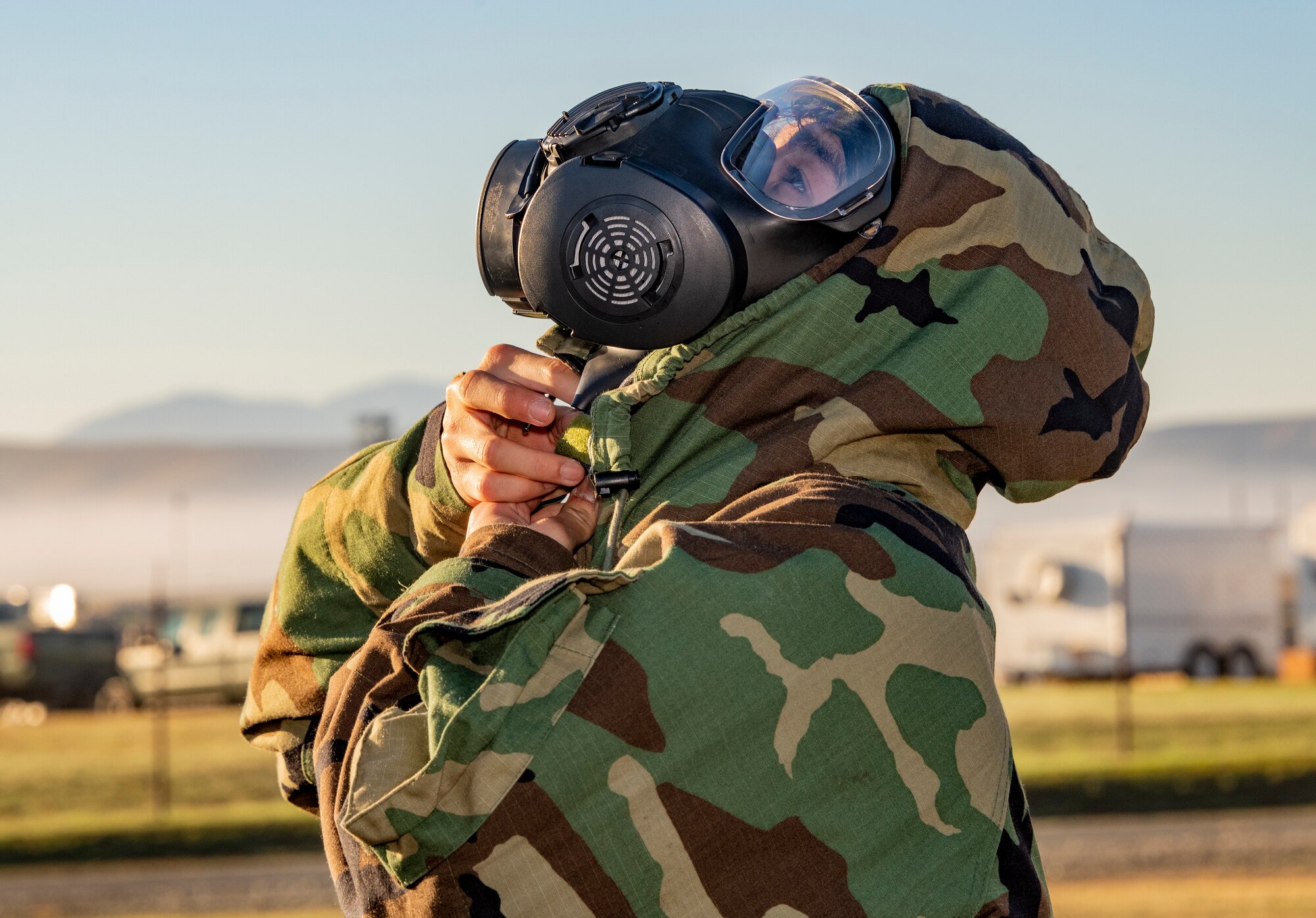Master Sgt. Jannett Orozco, 60th Operational Medical Readiness Squadron warrior medical flight chief, dons her Mission Oriented Protective Posture equipment during a training exercise on Oct. 28 2021, at Travis Air Force Base, California. The scenario required Airmen to properly don their gear during a chemical, biological, radiological, nuclear attack scenario. (U.S. Air Force photo by Heide Couch)