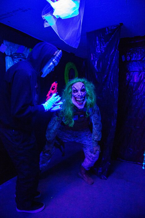 In the Among Us Maze portion of the Haunted Tunnel, Jump Scare Tall Clown, played by Colby Jacobs, and Jump Scare Joker, played by Trey White, stalk and spook guests during the 3rd annual Trunk or Treat event held aboard Marine Corps Logistics Base Barstow, California, Oct. 27.