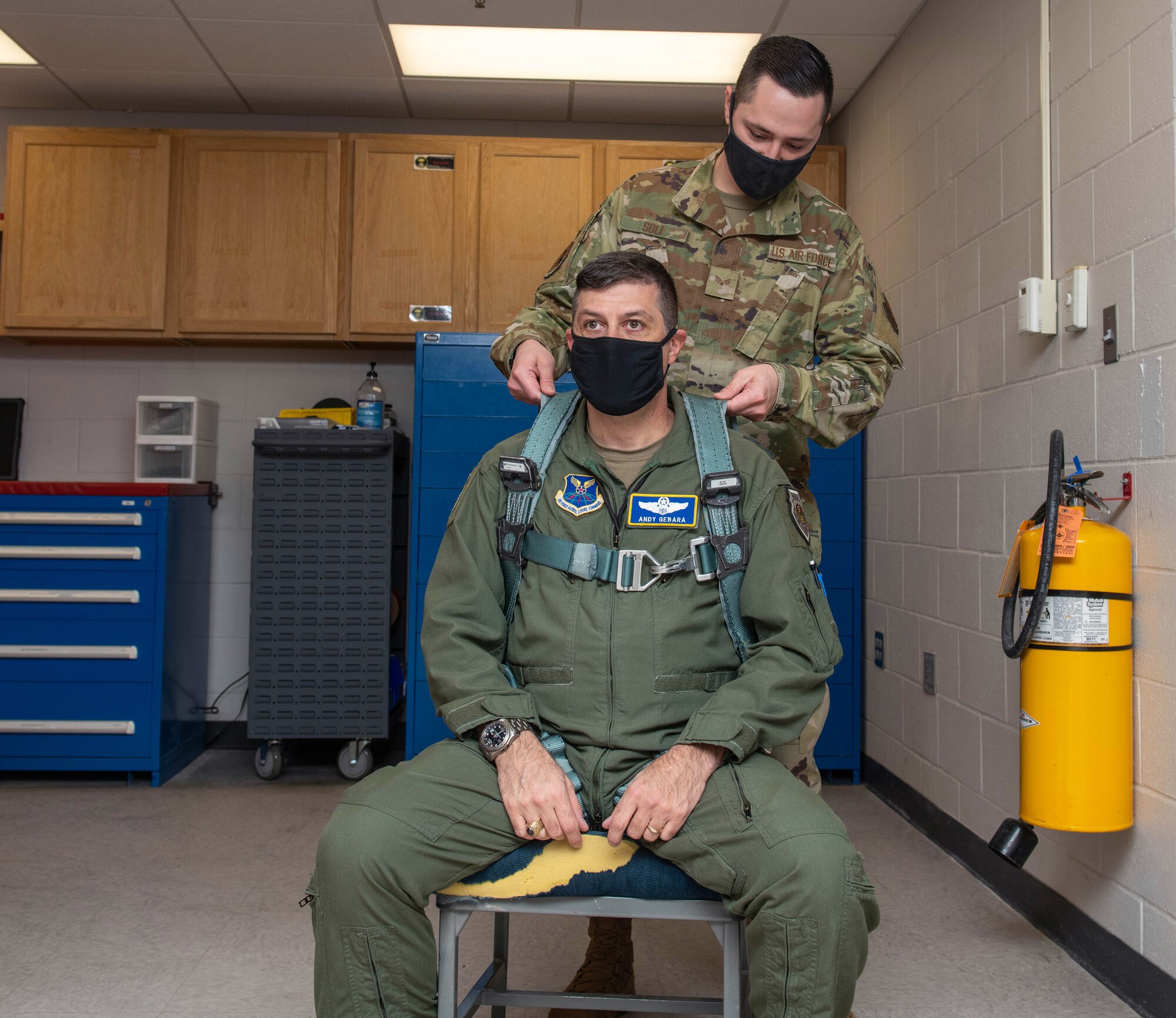 Senior Airman Jeremy Soli, 28th Operations Support Squadron aircrew flight equipment technician, assists Maj. Gen. Andrew Gebara, 8th Air Force and Joint-Global Strike Operations Center commander, with fitting his flight equipment at Ellsworth Air Force Base, S.D., Oct. 25, 2021. Gebara is responsible for the service’s bomber force and airborne nuclear command and control assets, encompassing approximately 21,000 Airmen across six installations. (U.S. Air Force photo by Airman 1st Class Quentin Marx)