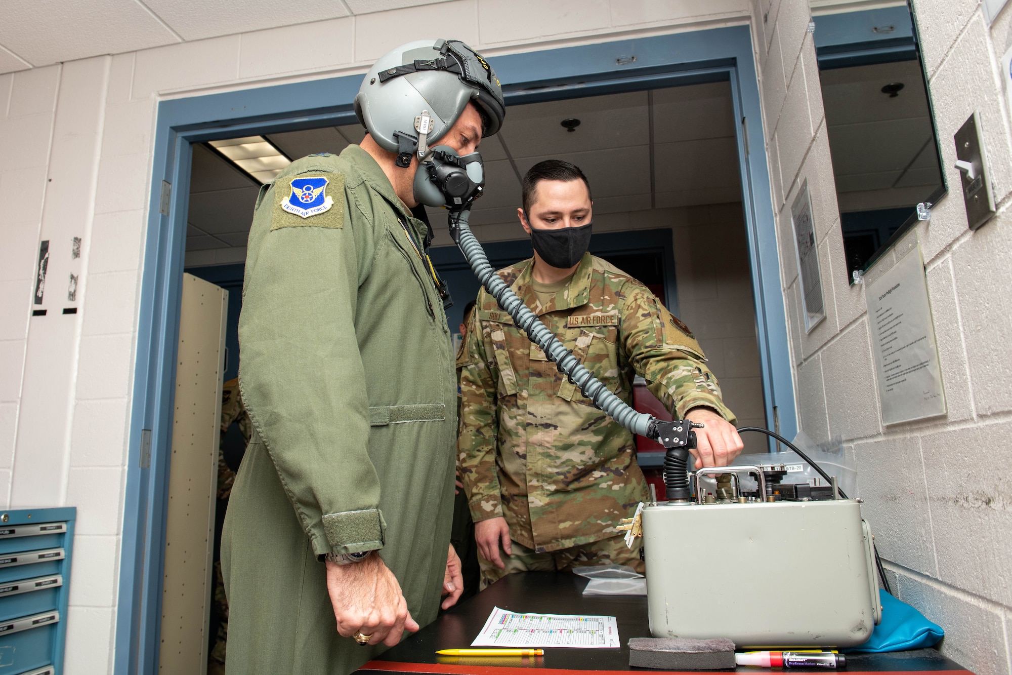 Senior Airman Jeremy Soli, 28th Operations Support Squadron aircrew flight equipment technician, and Maj. Gen. Andrew Gebara, 8th Air Force and Joint-Global Strike Operations Center commander, tests oxygen mask airflow at Ellsworth Air Force Base, S.D., Oct. 25, 2021. The J-GSOC serves as the central command and control node for all operations within Air Force Global Strike Command. (U.S. Air Force photo by Airman 1st Class Quentin Marx)