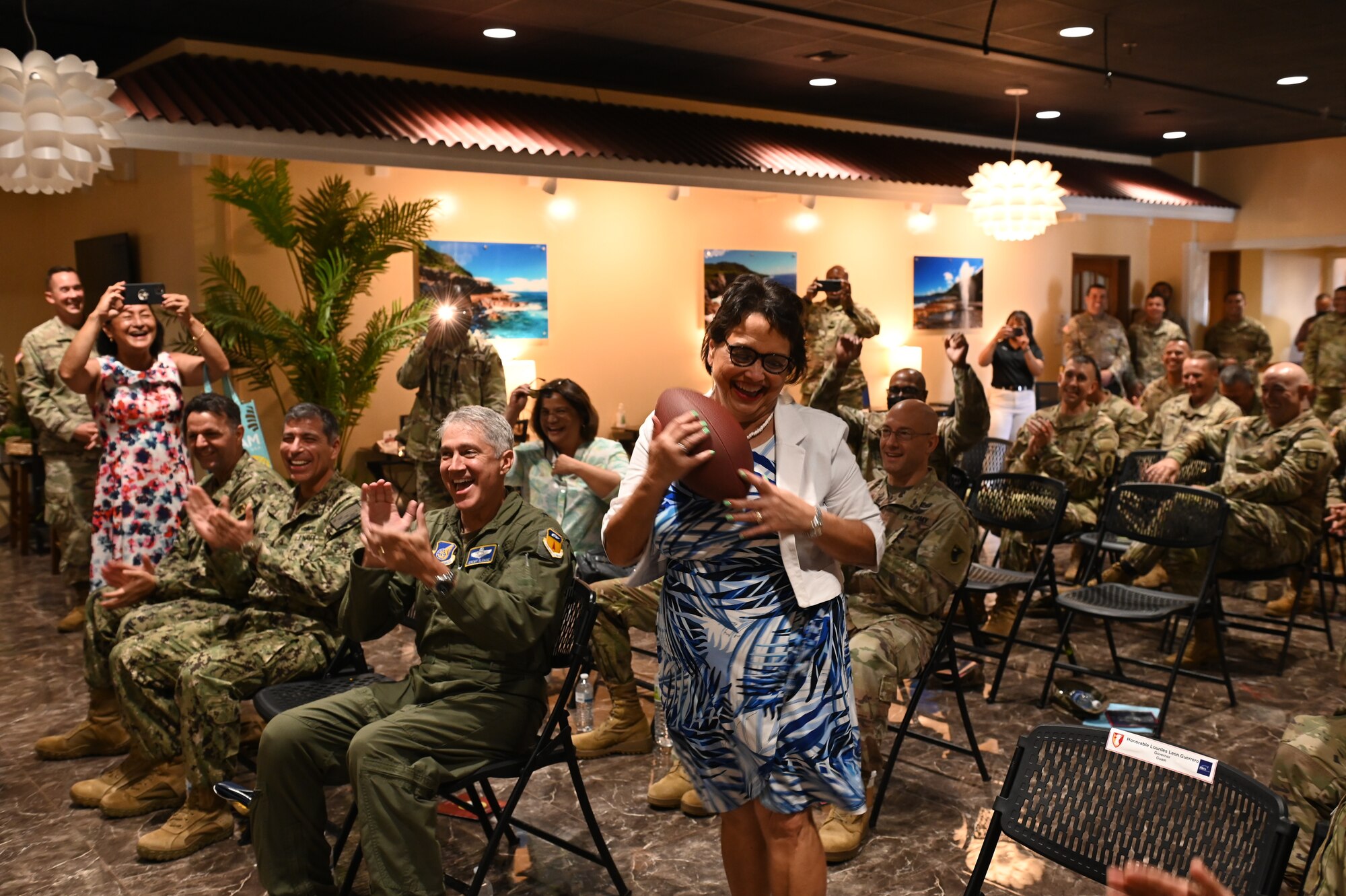 Gov. of Guam Lou Leon Guererro catches a football as part of a Pacific missile defender tradition at Andersen Air Force Base, Oct. 28, 2021.