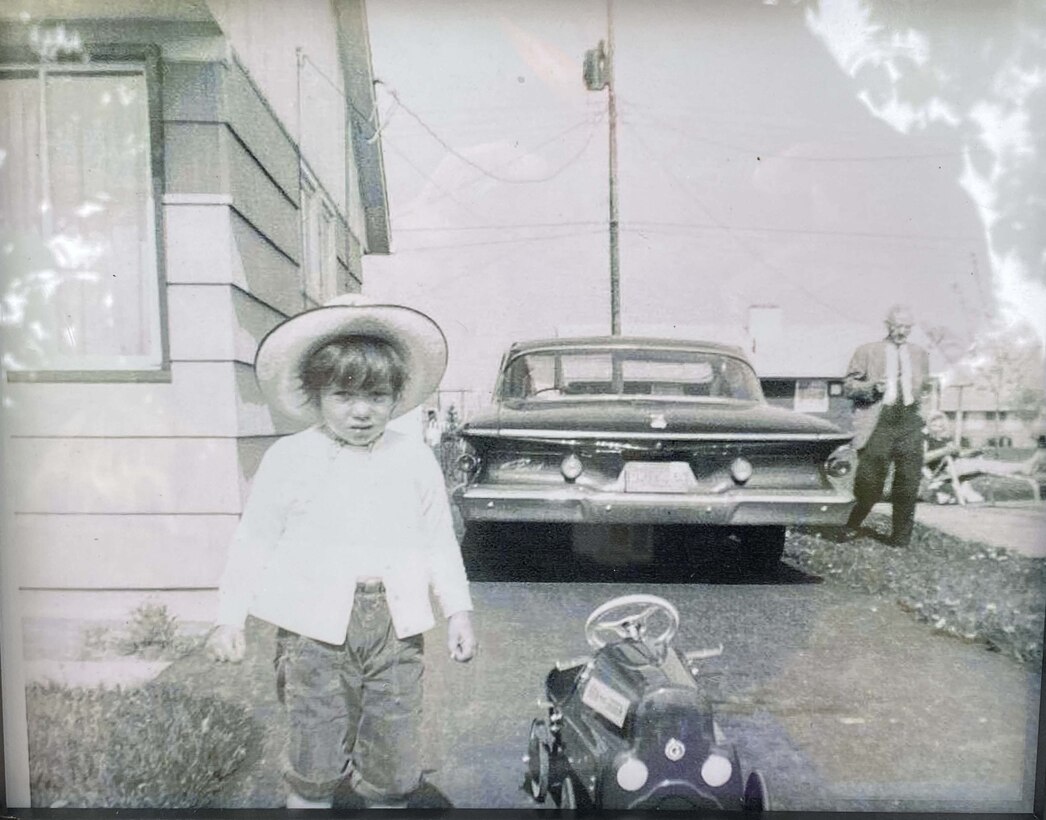 A black and white photo of Victoria "Vickie" Shepard, as a young child, on display on the memory table.