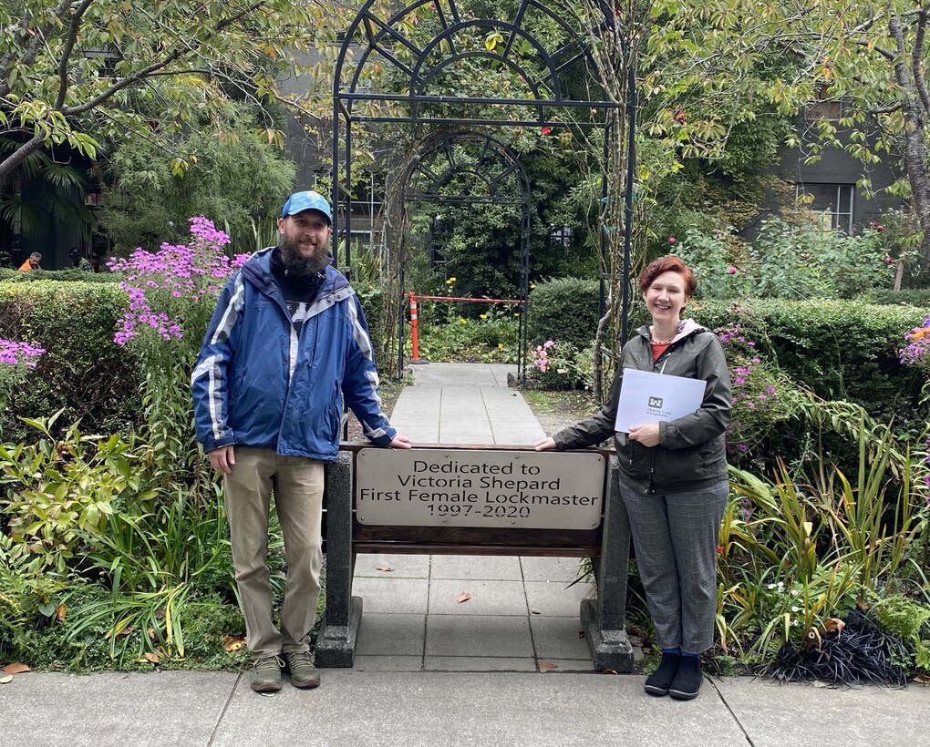 Jen Shepard, daughter of Victoria "Vickie" Shepard, and her husband, Eric, stand alongside the Victoria "Vickie" Shepard memorial bench .