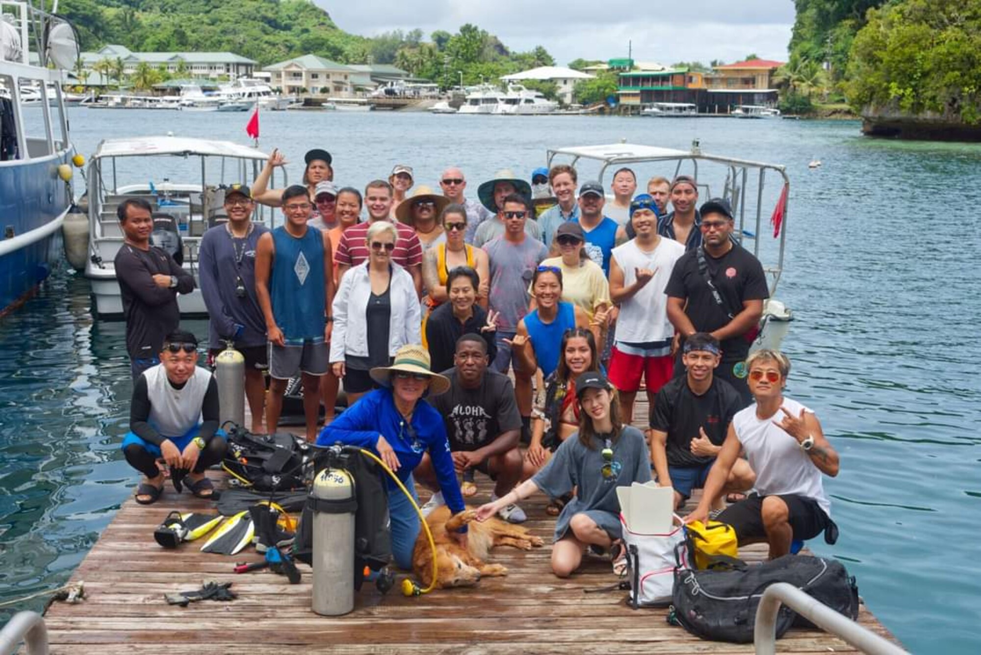 Members of the Civic Action Team Palau stand with some of the local community during a beach clean-up event. The CAT is working with locals on community projects, apprenticeship training, vehicle maintenance, medical support and construction. They will be on island into the New Year.  Some community events include cultural fairs, House of pain, beach clean-ups, reading to students and more. House of pain is a daily workout the CAT does with the locals to promote unity in the community while supporting the islands "Fit Palau" initiative. (Courtesy Photo)