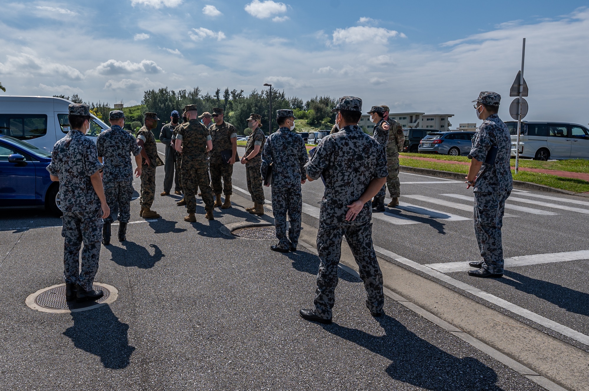 Airmen, Marines, and JASDF personnel talk with each other.