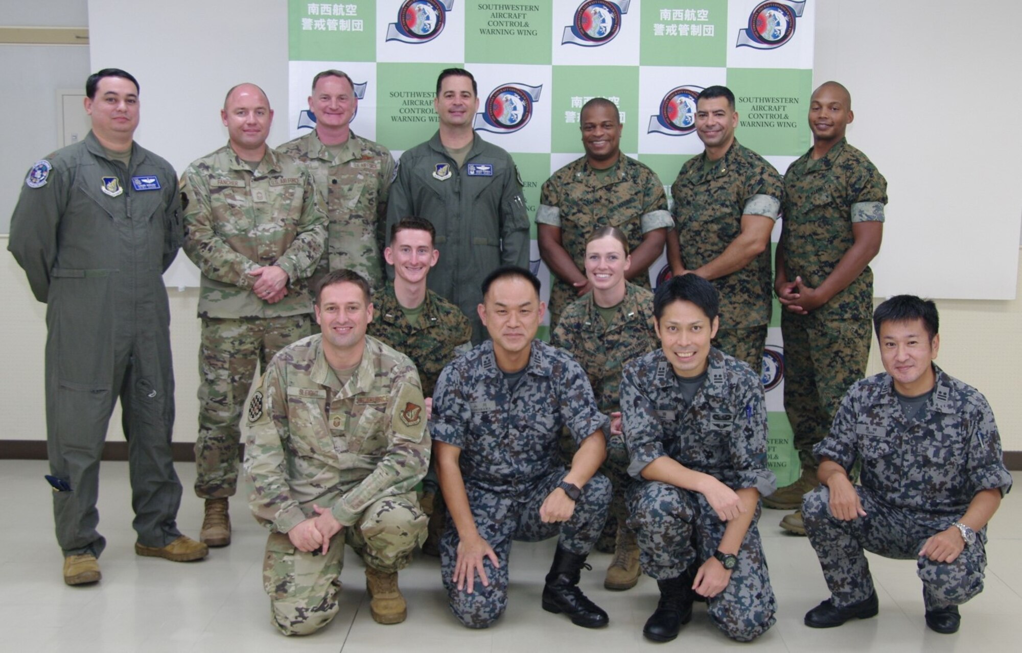 Airmen, Marines, and JASDF personnel pose for a picture.