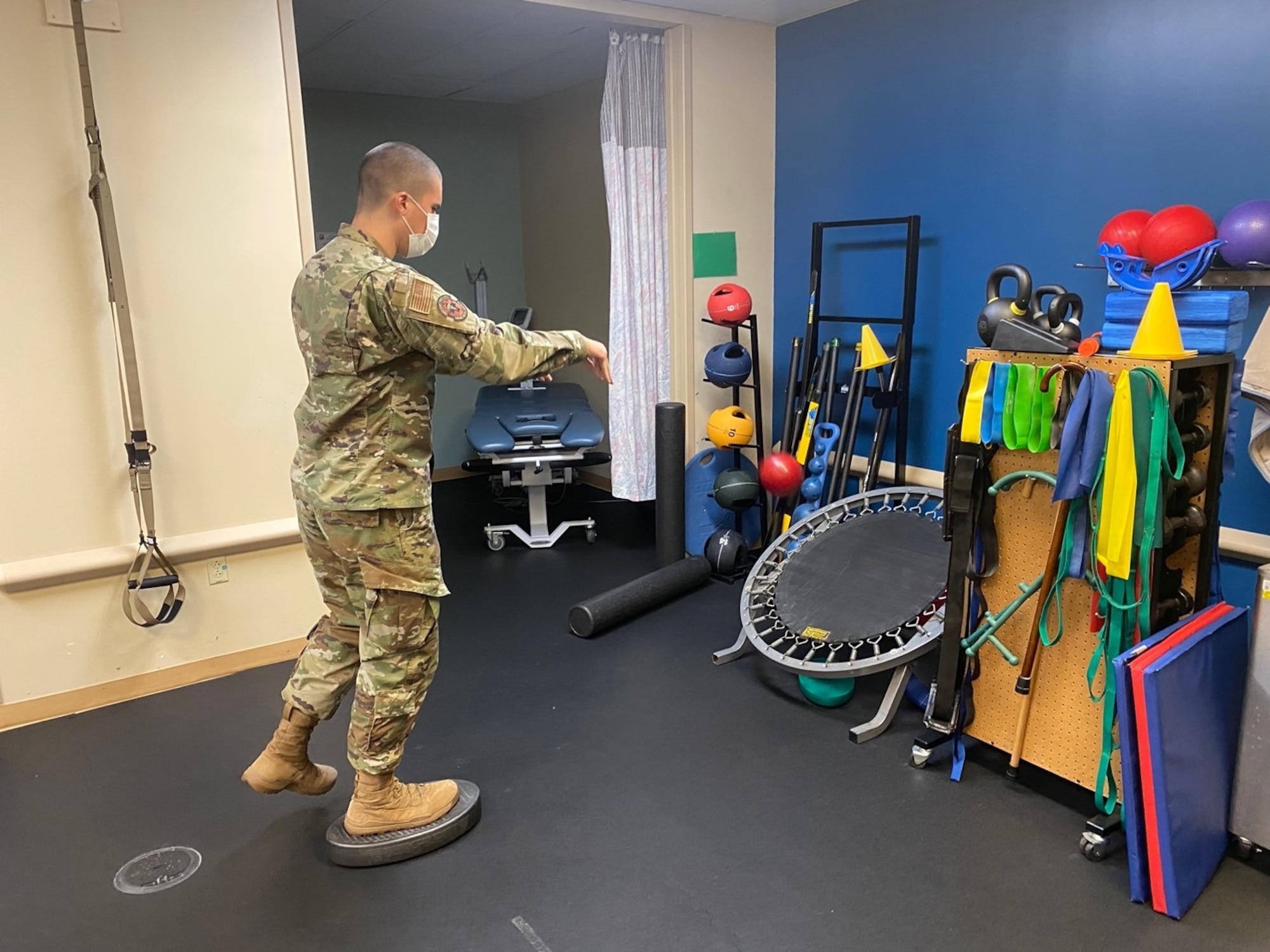 U.S. Air Force Staff Sgt. Timothy Montano, 6th Operational Medical Readiness Squadron physical therapy technician, makes balancing activities fun and challenging while tossing a weighted ball towards a trampoline at MacDill Air Force Base, Florida, Oct. 26, 2021. During the month of November, the physical therapy team will be leading a pilot program called the senior fitness trainer course, which aims to redefine and enhance the current Air Force physical training leader certification by creating a holistic approach to readiness and resiliency. (U.S. Air Force photo)